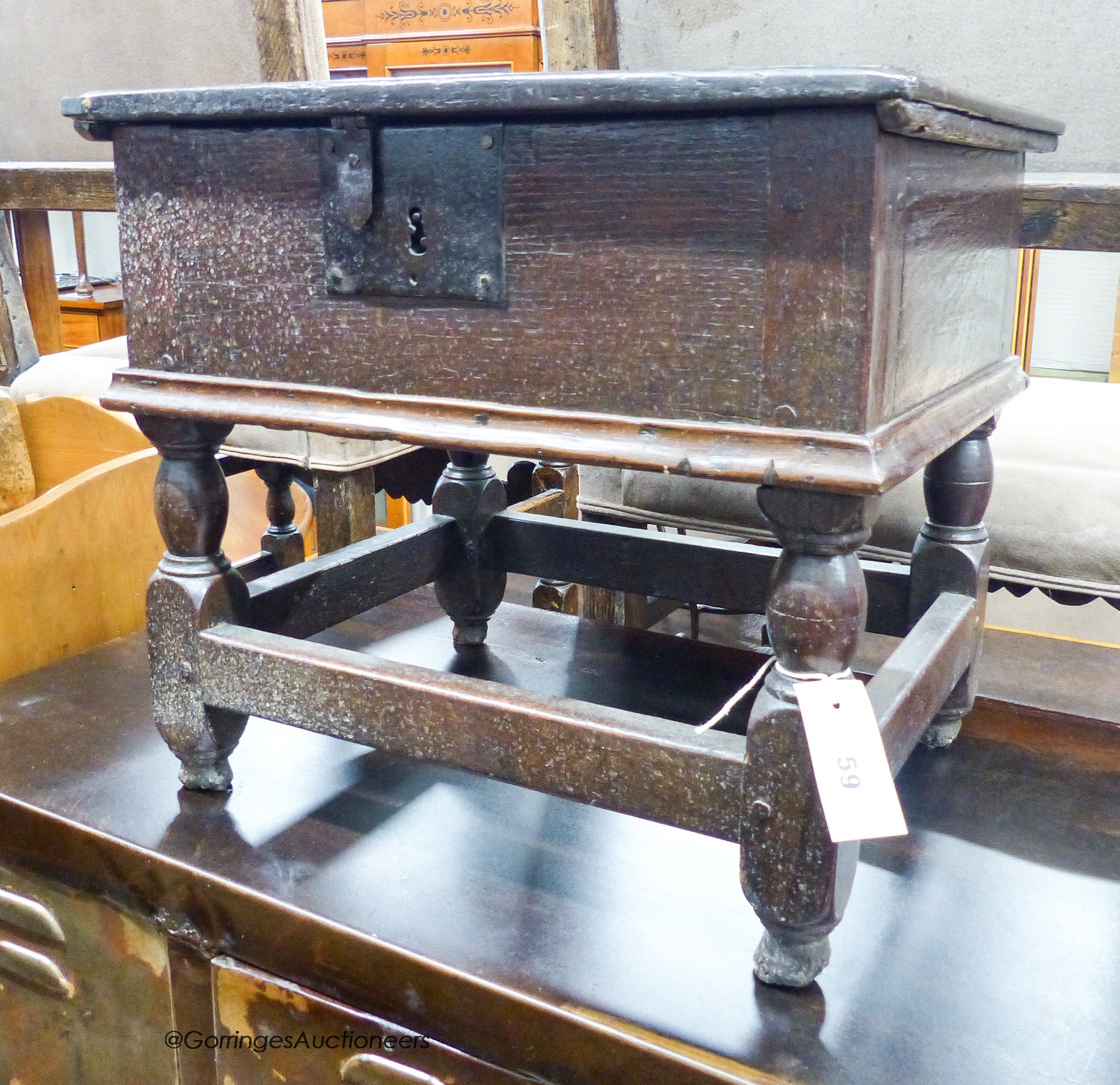 A 17th century oak box stool with hinged rectangular seat, width 46cm, depth 38cm, height 42cm
